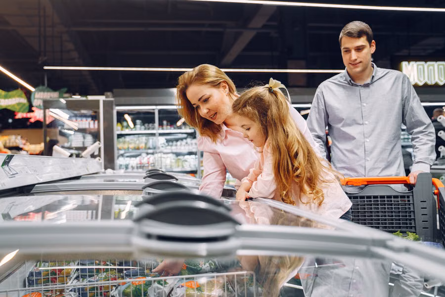 Fröhliche Familie beim Einkaufen im Supermarkt